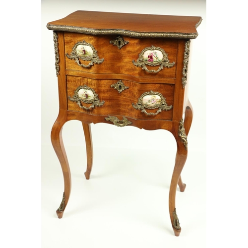 802 - A serpentine shaped French walnut and brass mounted Petite Commode, with brass mounts and porcelain ... 