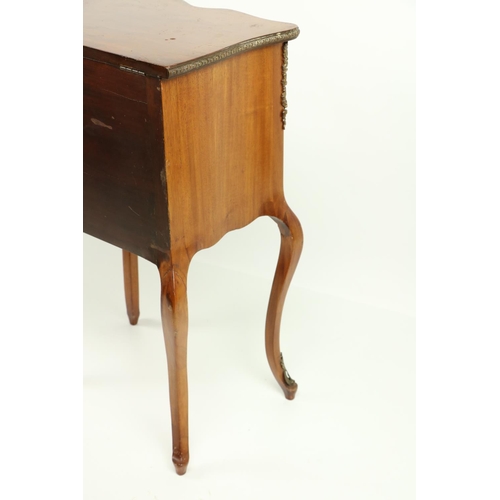 802 - A serpentine shaped French walnut and brass mounted Petite Commode, with brass mounts and porcelain ... 