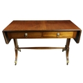 A Regency style mahogany drop leaf Sofa Table, with two rectangular flaps flanking two frieze drawer... 