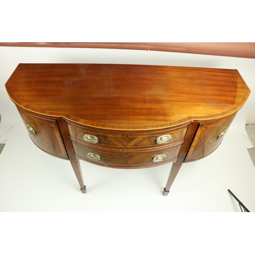 817 - A serpentine fronted inlaid and crossbanded mahogany Sideboard, with two long centre drawers flanked... 