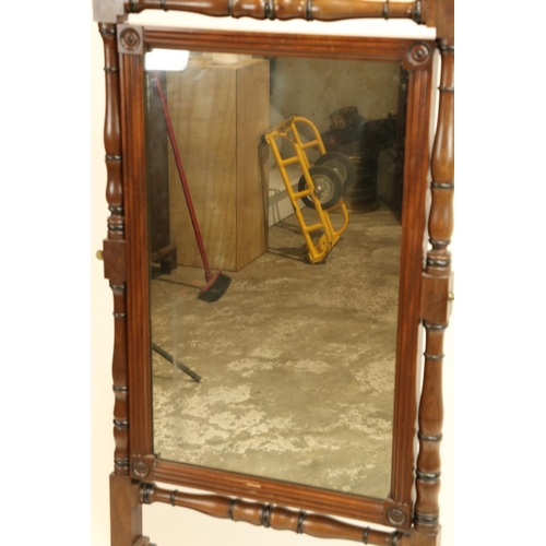 827 - A George IV period mahogany and ebony Cheval Mirror, the ring turned baluster frame with fluted urn ... 