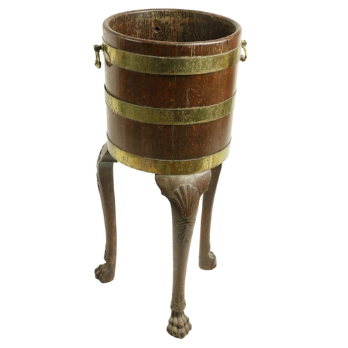 840 - A brass bound Irish oak Jardinière, with two brass handles raised on shell capped cabriole legs with... 