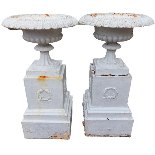 1014 - A pair of attractive tall Victorian cast iron Urns on stands, with egg and dart rims outsplayed pill... 