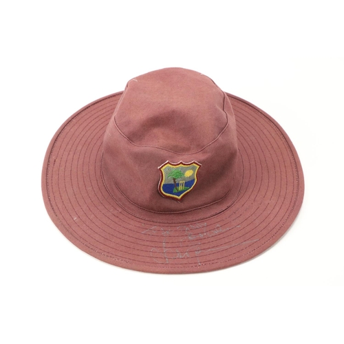 1052 - Signed by Brian LaraCricket: A West Indies purple Sun Hat, with crest Signed in silver pen 'To ... 