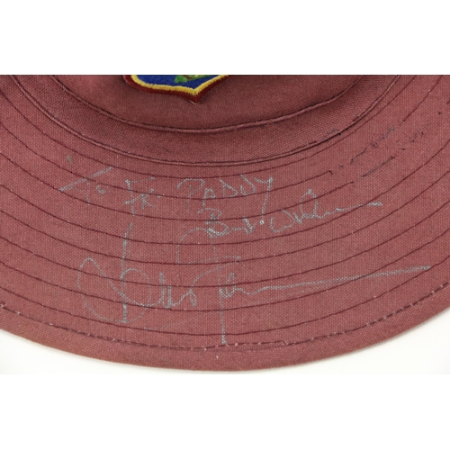 1052 - Signed by Brian LaraCricket: A West Indies purple Sun Hat, with crest Signed in silver pen 'To ... 