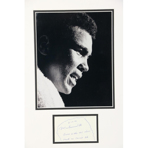 1058 - [Ali (Muhammad)] A framed black and white press Photograph of Ali, side profile with towel around hi... 