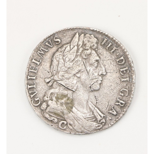 1111 - Coin:  A silver 1697 William III Coin, the obverse with side profile, the outer section inscribed 'G... 