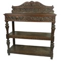 A 19th Century Cromwellian style carved oak Buffet, the shaped back with central carved grotesque ma... 