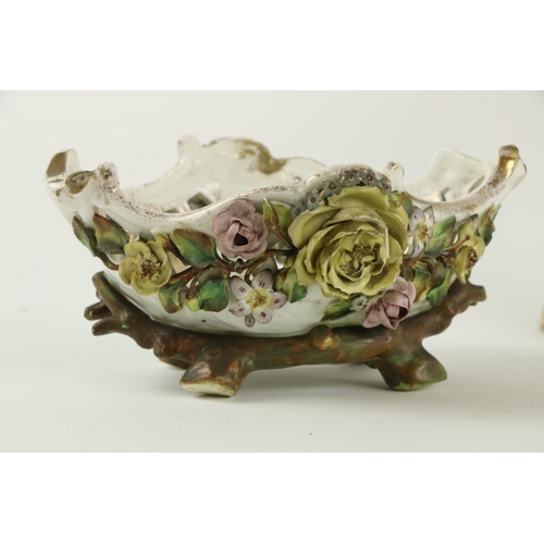 45 - A Sitzendorf porcelain Centerpiece, the pierced flower encrusted basket with floral panels on a flow... 