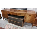 An inlaid and bow fronted mahogany Sideboard, 19th Century with centre mock frieze drawer, flanked e... 
