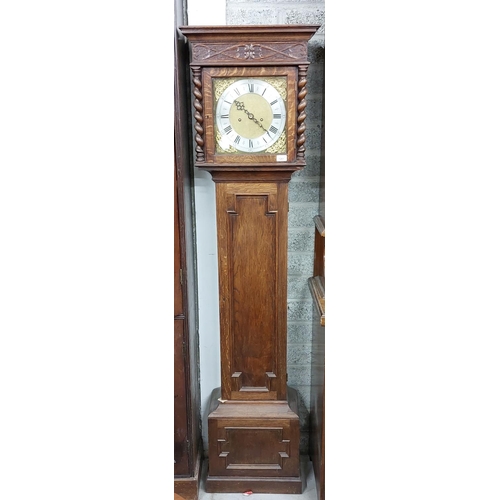 68 - An oak Longcase Clock, in the 19th Century style, with moulded cornice above a carved frieze and a b... 