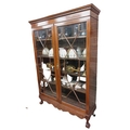A Chippendale style mahogany Display Cabinet, with dentil moulded cornice above two astragal glazed ... 