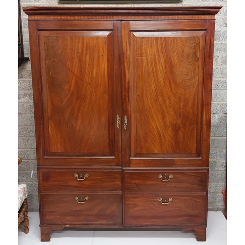 200 - A Georgian mahogany Wardrobe, with moulded cornice above two fielded panel doors incorporating four ... 