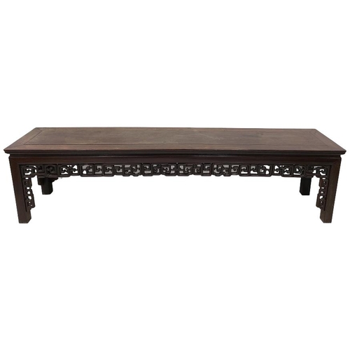 230 - A heavy Chinese cherrywood Table or Bench, of oblong form with Greek key moulded frieze on square mo... 