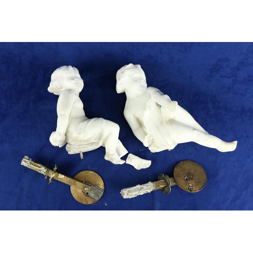 410 - A pair of 19th Century carved white marble Figures, of seated cherubs 28cms (11''), each on a circul... 