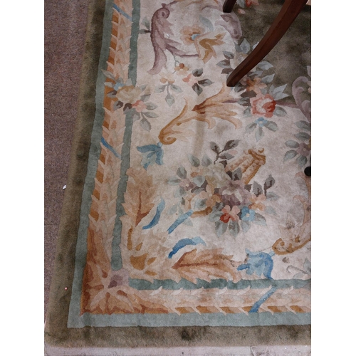 433 - A 20th Century Chinese heavy woollen cream and green ground Carpet, with central bouquet and green b... 