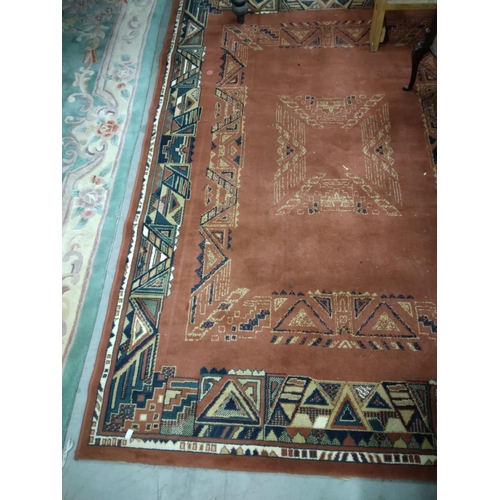 434 - An Art Deco style burgundy ground woollen Carpet, with typical geometric design, 231cms x 163cms (7'... 