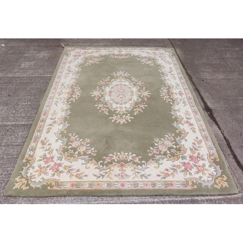 435 - An attractive Tolech design Inolius woollen Carpet, the green ground with central floral motif and s... 