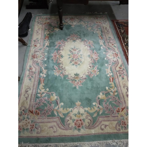 437 - An attractive heavy woollen Chinese green ground floral decorated Carpet, approx. 253cms x 172cms (8... 