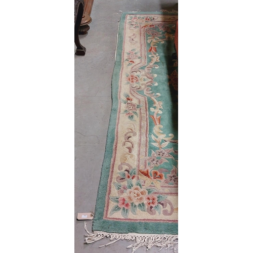 437 - An attractive heavy woollen Chinese green ground floral decorated Carpet, approx. 253cms x 172cms (8... 