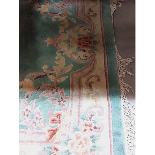 437 - An attractive heavy woollen Chinese green ground floral decorated Carpet, approx. 253cms x 172cms (8... 