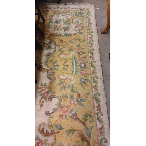 441 - A large cream ground heavy woollen Carpet, with central floral panel and shaped similar decorated bo... 