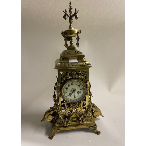 144 - A 19th Century Baroque style pierced decorated brass Mantle Clock, the ornate finial over circular e... 