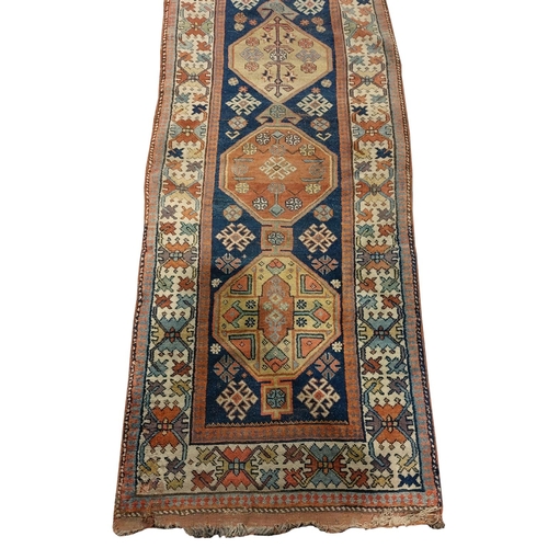 439 - A fine quality antique Carpet / woollen Runner, the central dark blue ground panel with eight medall... 