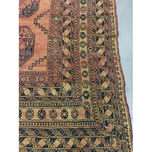 440 - An unusual late 19th Century / early 20th Century Middle Eastern orange ground woollen Carpet, the r... 