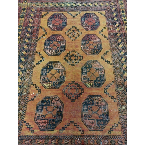 440 - An unusual late 19th Century / early 20th Century Middle Eastern orange ground woollen Carpet, the r... 