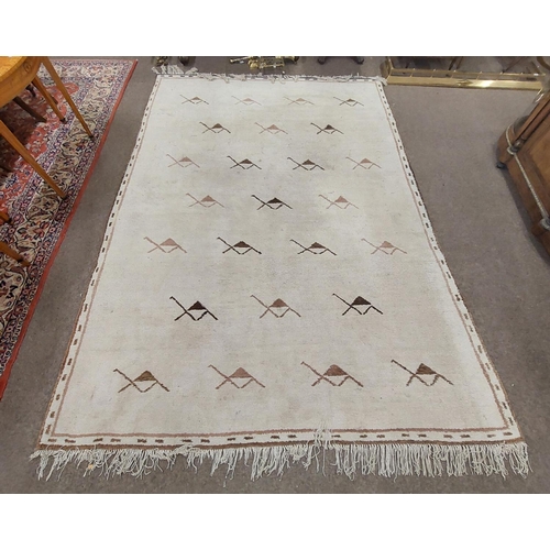 33 - A large heavy pile Middle Eastern fawn ground woollen Carpet, with geometric design and slim border,... 