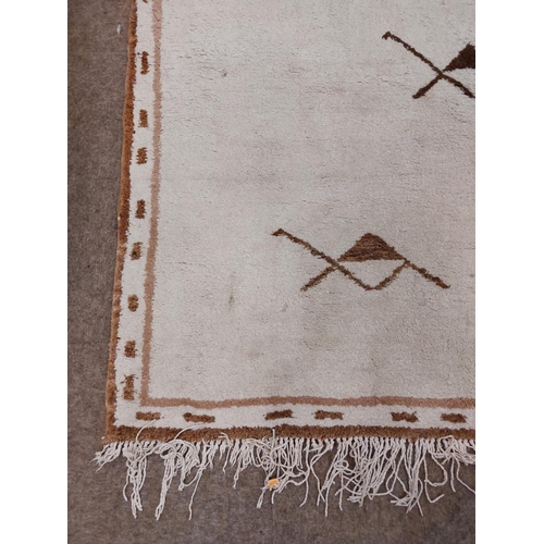 33 - A large heavy pile Middle Eastern fawn ground woollen Carpet, with geometric design and slim border,... 