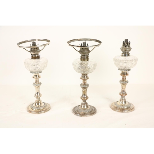 191 - A set of 3 late 19th Century silver plated Candlestick Oil Lamps, with cutglass reservoirs, 32cms (1... 