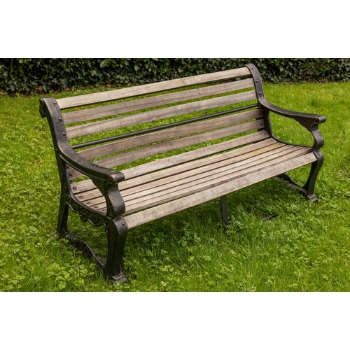 552 - A cast iron Coalbrookdale type Garden Bench, with teak slatted seat and back, the arm rests with ram... 