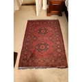 A good burgundy ground Afghan Rug, with two medallions inside conforming border, 152cms x 101cms (60... 