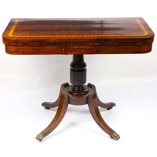 79 - A Regency period fold-over rosewood Card Table, with satinwood banding above a panelled frieze raise... 