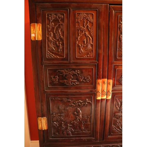 97 - A carved hardwood Cabinet (GUI) Qing Dynasty, of rectangular outline with a pair of hinged doors sep... 