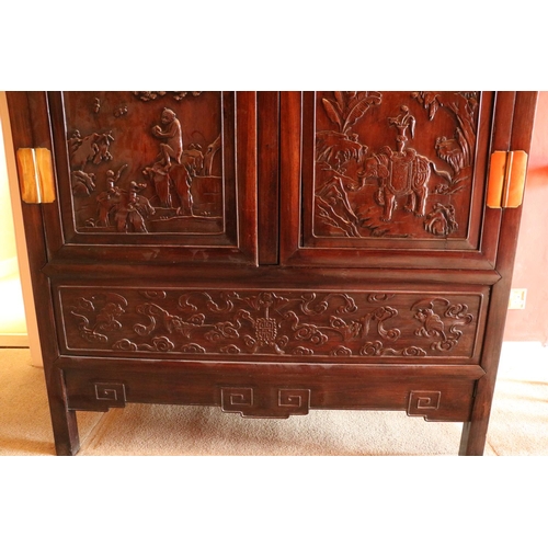 97 - A carved hardwood Cabinet (GUI) Qing Dynasty, of rectangular outline with a pair of hinged doors sep... 