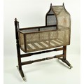 A good 19th Century Gothic style mahogany Child's Rocking Cradle, with caned panels under an arched ... 
