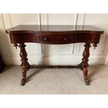 A Victorian serpentine fronted Dressing Table, with frieze drawer on turned supports united with tur... 