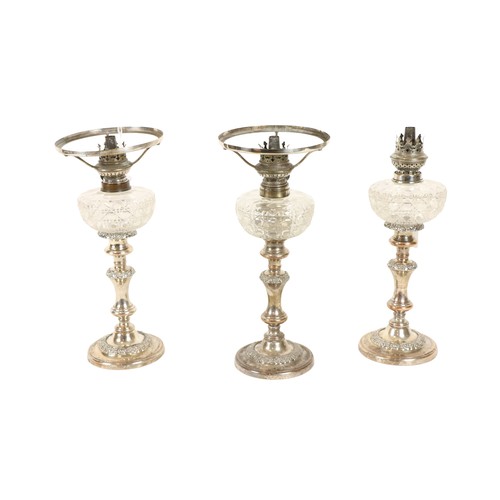 191 - A set of 3 late 19th Century silver plated Candlestick Oil Lamps, with cutglass reservoirs, 32cms (1... 