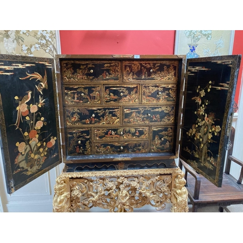 94 - An exceptional fine 18th Century chinoiserie lacquered two door Cabinet on Stand, the interior with ... 