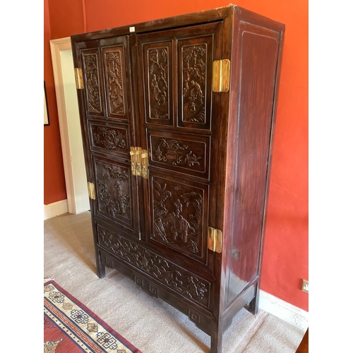 97 - A carved hardwood Cabinet (GUI) Qing Dynasty, of rectangular outline with a pair of hinged doors sep... 