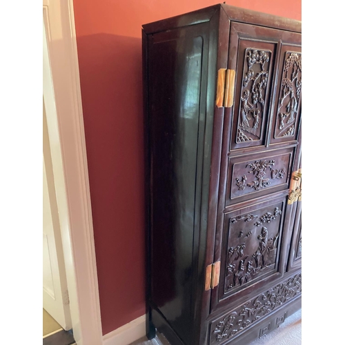 97 - A carved hardwood Cabinet (GUI) Qing Dynasty, of rectangular outline with a pair of hinged doors sep... 