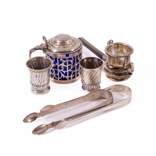 63 - A crested and pierced silver Pot and cover, and blue glass liner, a Novelty swivel Tea Strainer, two... 