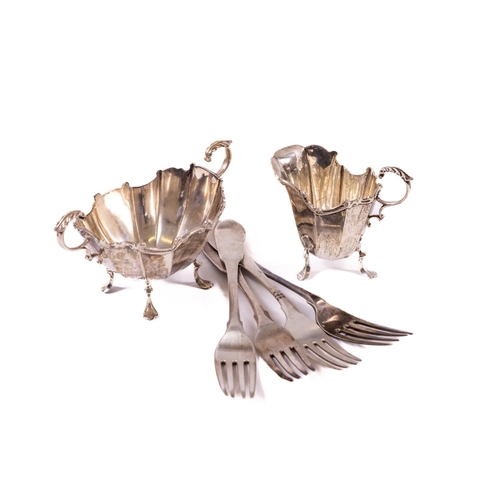 74 - A Birmingham silver Sugar and Cream, the boat shaped double handled bowl on four legs and a matching... 