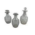 A pair of small early 19th Century Irish cutglass Carafes, each with a series of ovals above a wide ... 