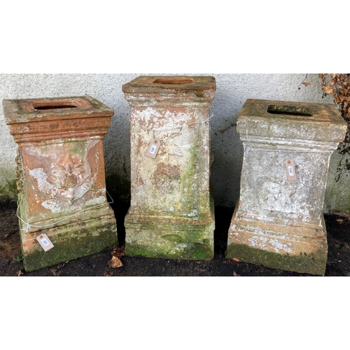 1350 - Three similar old terracotta Garden Urn Stands, each with relief moulded panels, the tallest 79cms (... 