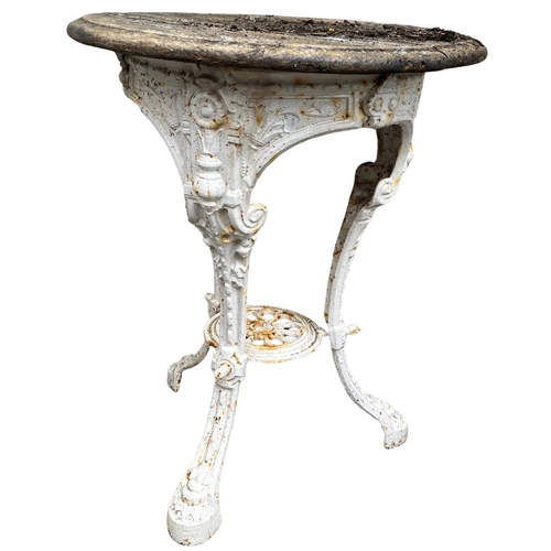 1403 - A Victorian cast iron Patio Table, the circular wooden moulded top on triform base with shelf stretc... 