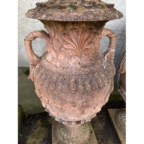 1373 - An impressive pair of terracotta coloured composition stone Garden Urns, each relief moulded with sc... 